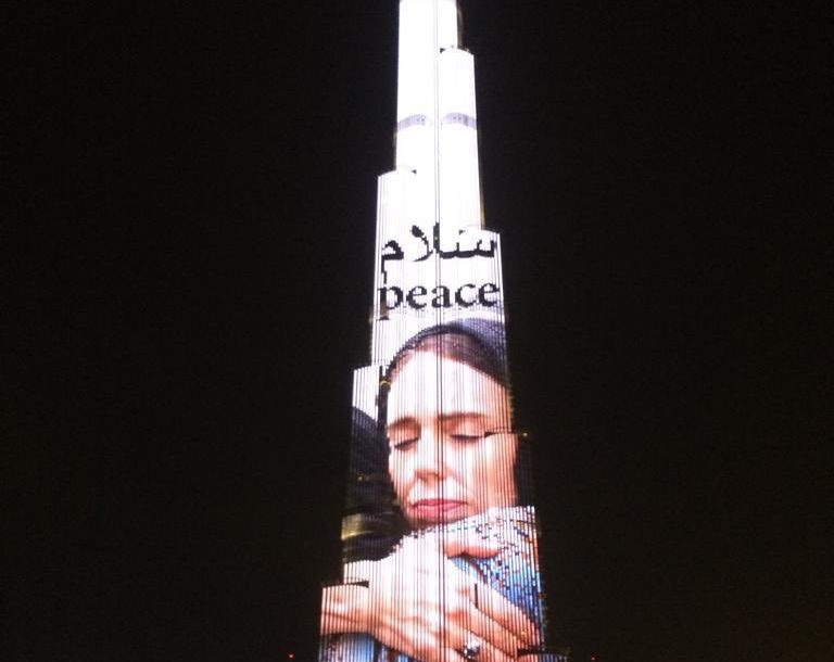 Latest International News : Burj Khalifa lights up with New Zealand PM Jacinda Ardern's photo to pay tribute